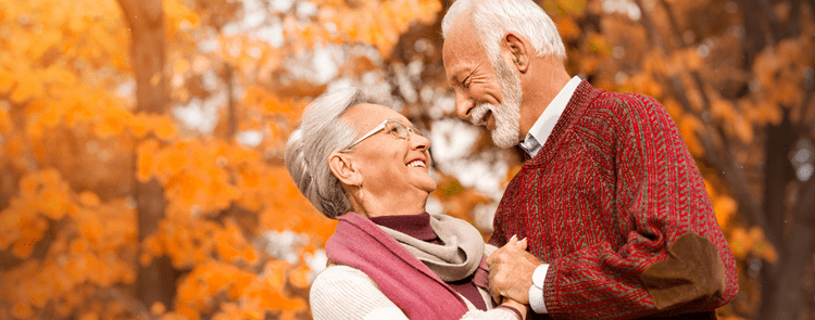 man and woman hugging outside during a cool autumn day.